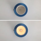 Clérachic's blue coffee-cup light is shown unlit, then glowing, in this before-and-after pair.
