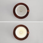The Clérachic coffee-brown coffee-cup light appears unlit, then glowing, side by side.