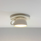 The Clérachic white coffee-cup ceiling light is shown close up against a plain ceiling.
