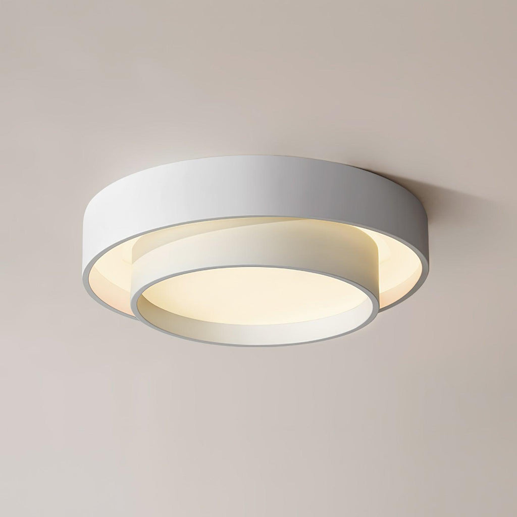 The Clérachic gray double-ring ceiling light glows warm, photographed from below at an angle.