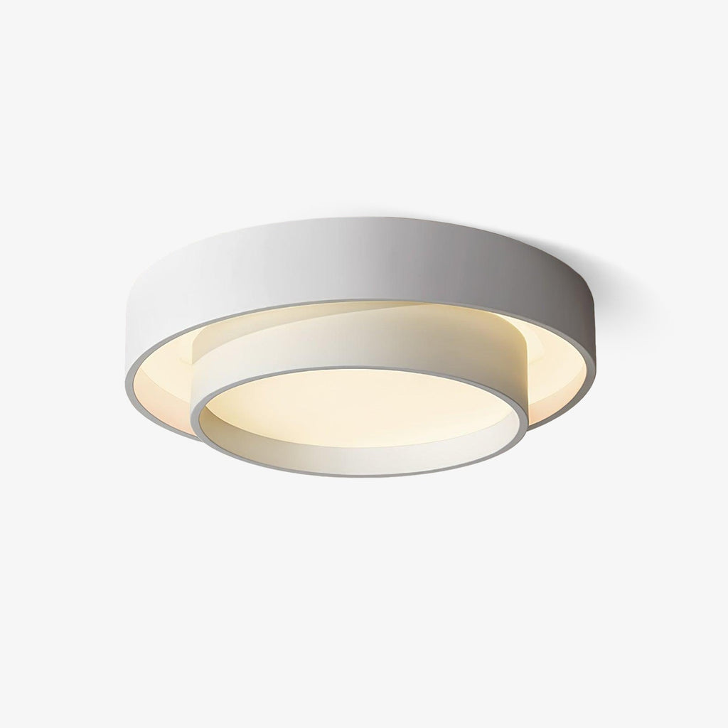 Clérachic's gray double-ring flush mount glows warm, centred straight on a plain wall.