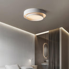 The Clérachic gray double-ring ceiling light glows warm above a bedroom curtain and headboard.