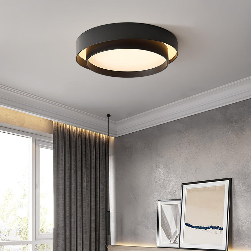 Clérachic's black double-ring flush mount glows warm in a room with gray curtains and framed art.