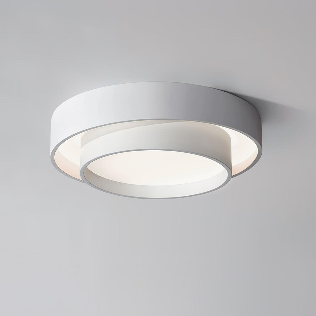 The Clérachic white double-ring ceiling light is shown close up, its acrylic diffuser glowing.