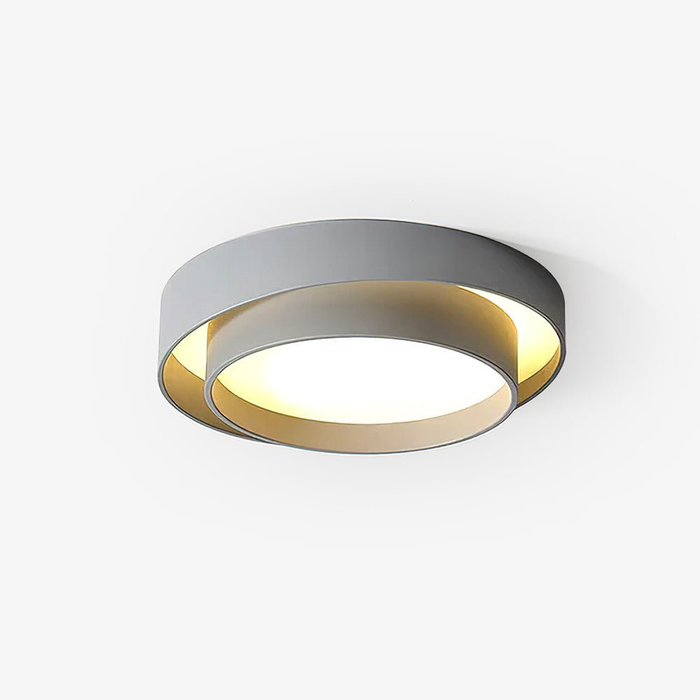 The Clérachic gray double-ring ceiling light is shown close at an angle, rings glowing warm.