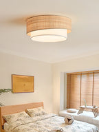 Fitted flush to the ceiling, this Clérachic light glows above a bedroom with wood blinds and floral-print bedding.