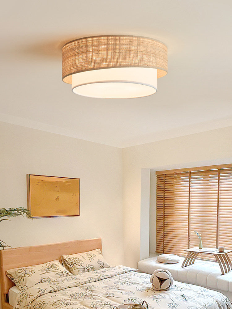 Fitted flush to the ceiling, this Clérachic light glows above a bedroom with wood blinds and floral-print bedding.