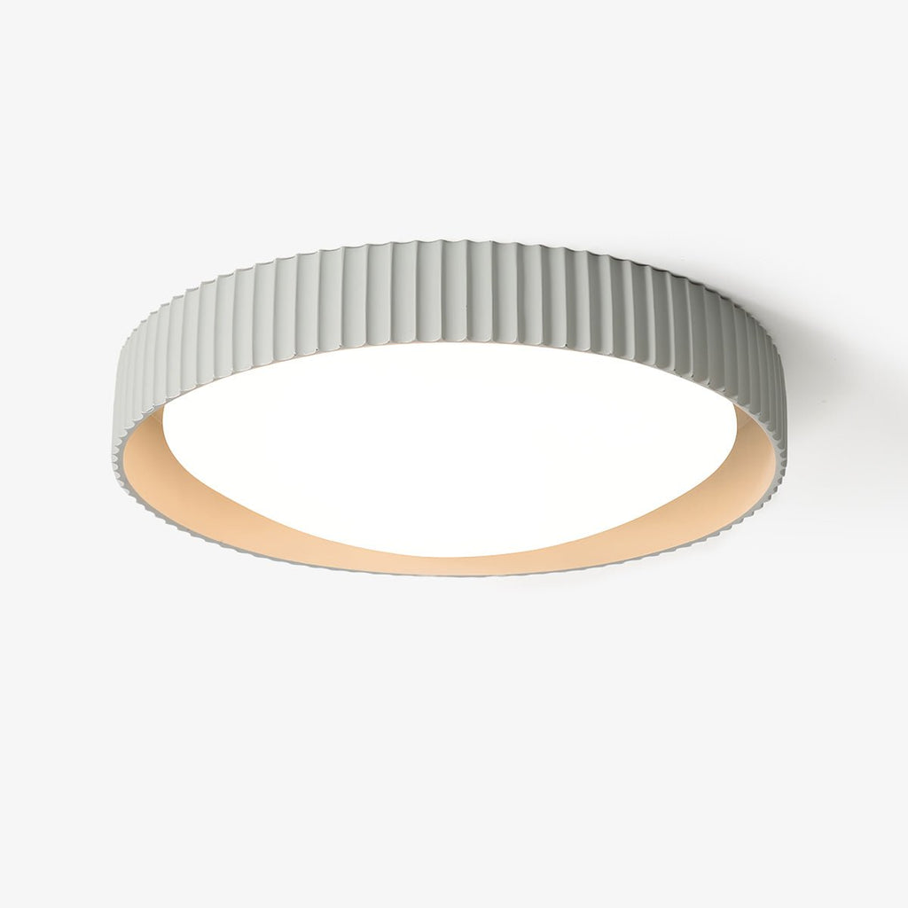 This Clérachic flush ceiling light on a plain white backdrop, a pale grey ribbed shade around a round white diffuser with a cream inner rim.
