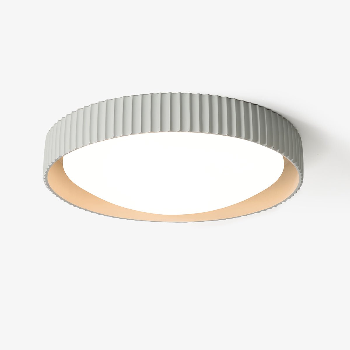 This Clérachic flush ceiling light on a plain white backdrop, a pale grey ribbed shade around a round white diffuser with a cream inner rim.
