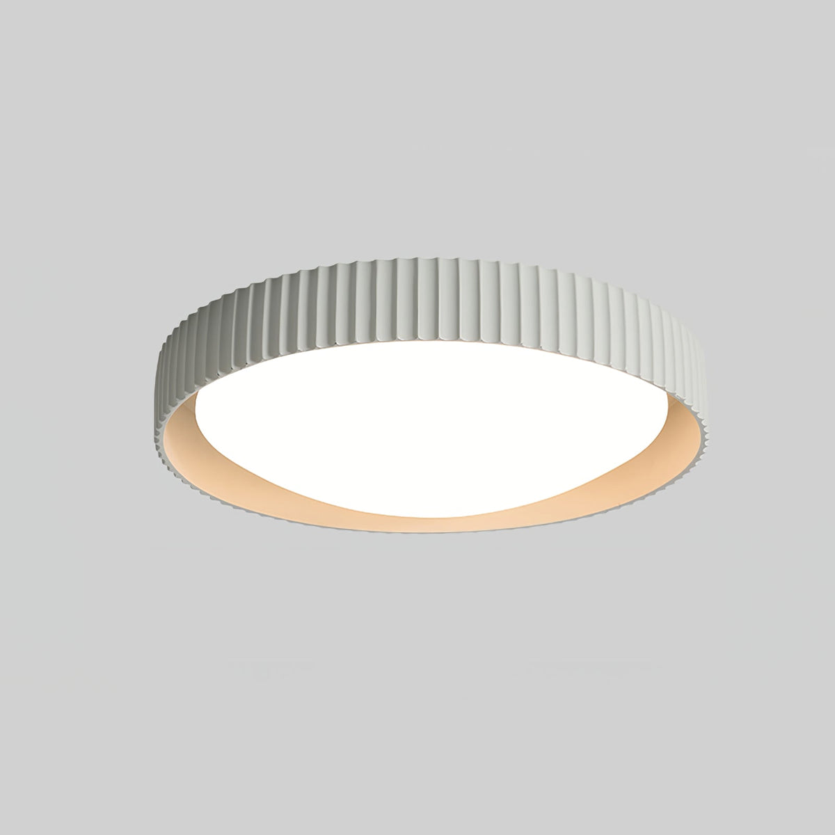 A Clérachic flush ceiling light in a very pale grey-white, its ribbed rim and diffuser seen from below against a mid-grey backdrop.