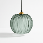 Clérachic ribbed opaline glass pendant light in sage green with a brass ceiling canopy, styled solo and unlit on white.