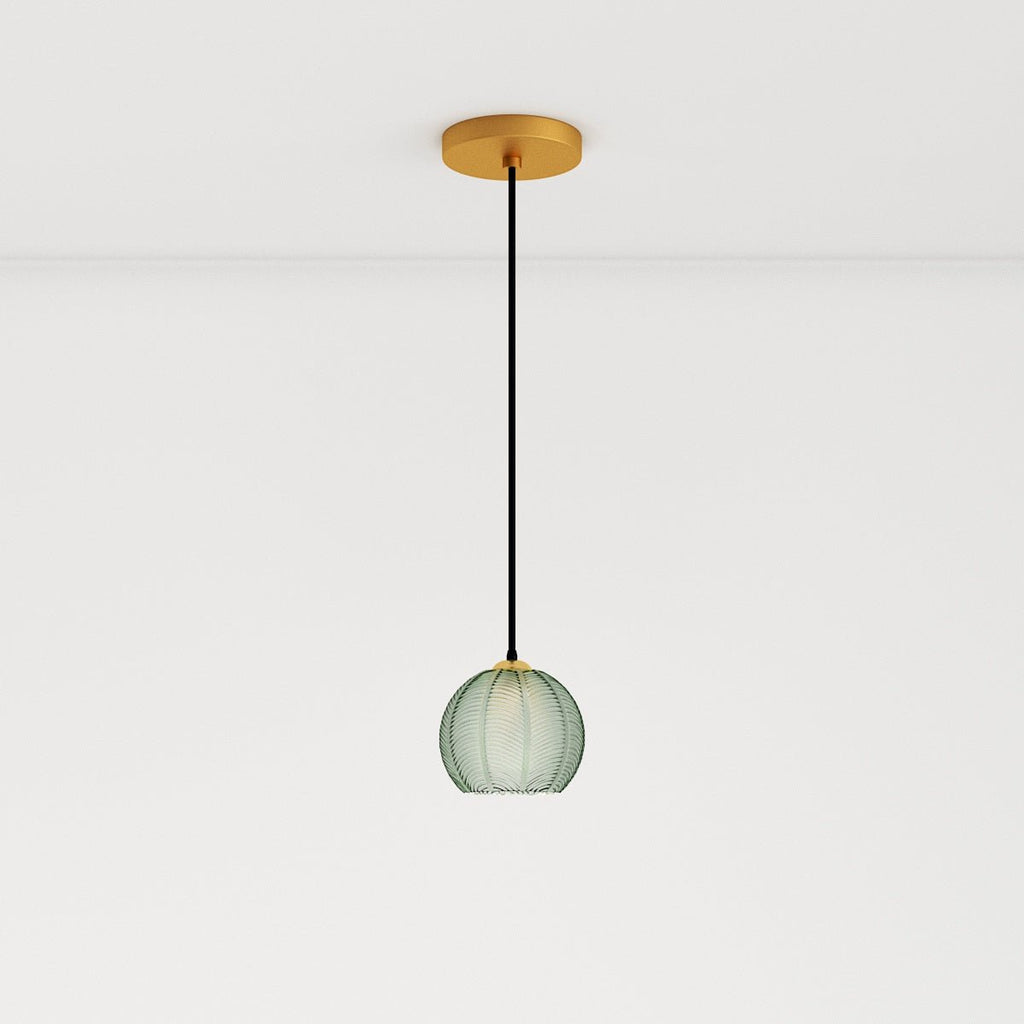 Clérachic ribbed opaline glass pendant light in sage green on a long cord from a round brass ceiling canopy, unlit.