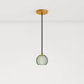 Clérachic ribbed opaline glass pendant light in sage green on a long cord from a round brass ceiling canopy, unlit.