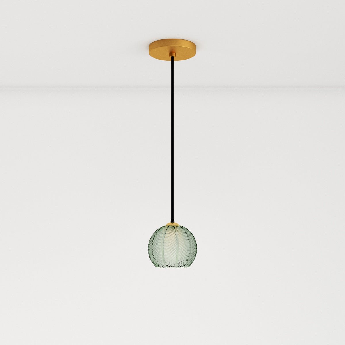 Clérachic ribbed opaline glass pendant light in sage green on a long cord from a round brass ceiling canopy, unlit.