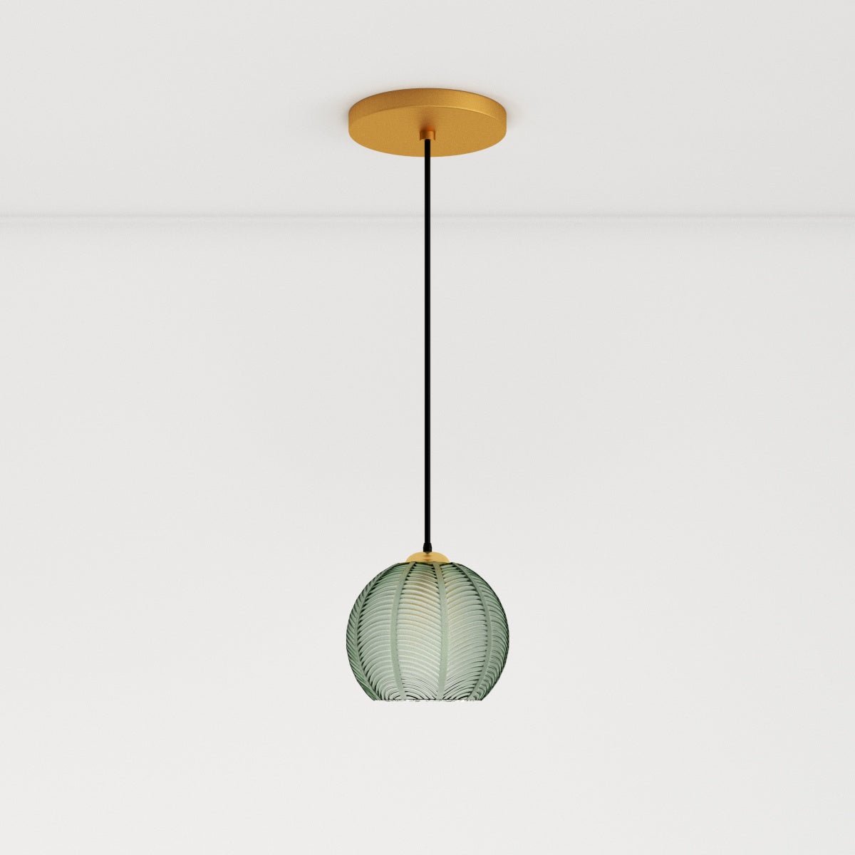 Clérachic ribbed opaline glass pendant light in sage green on a long black cord from a brass ceiling canopy, unlit.