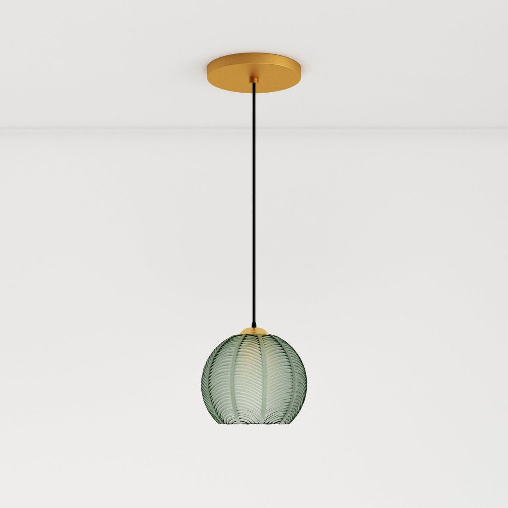 Clérachic ribbed opaline glass pendant light in sage green on a long cord from a brass canopy, glowing warm white.