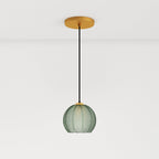 Clérachic ribbed opaline glass pendant light in sage green on a long cord from a brass canopy, glowing warm white.