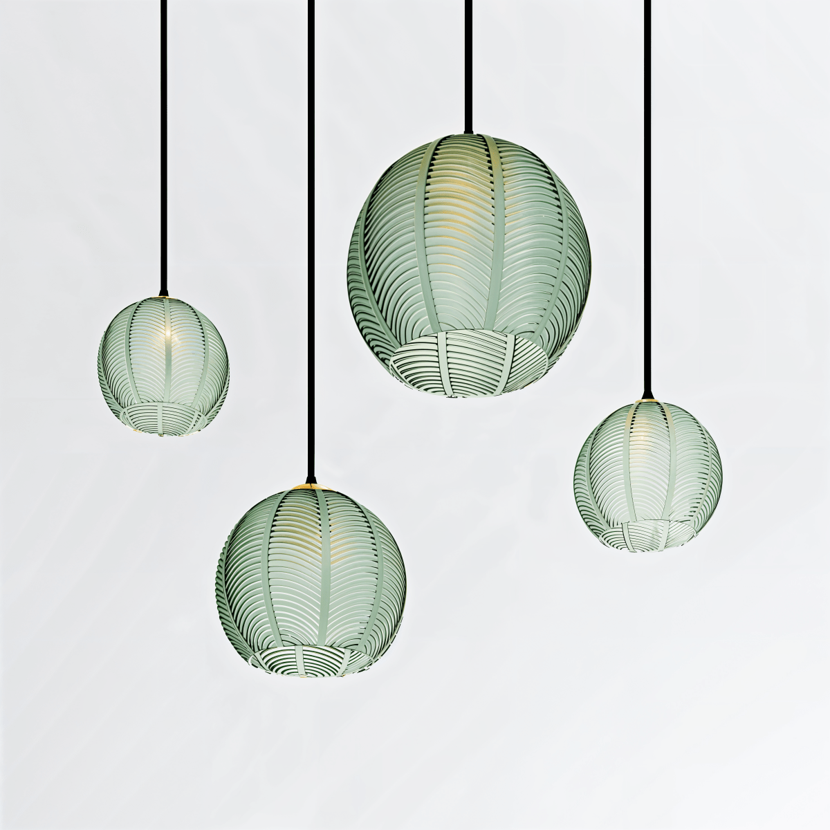 Clérachic ribbed opaline glass pendant lights in sage green, four fixtures glowing warm together against white.
