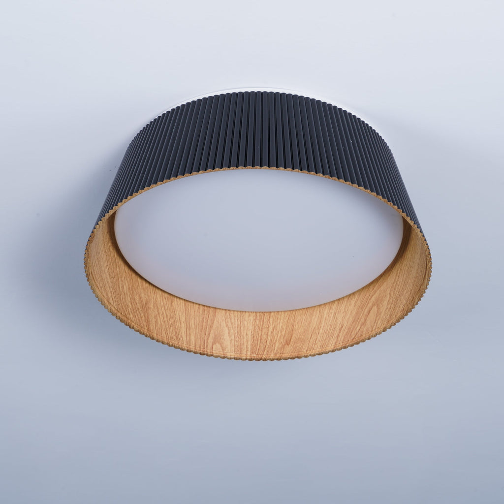 Black Clérachic ceiling light seen from a low angle, with a frosted diffuser inside its wood-grain rim.