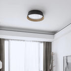 Small black Clérachic ceiling light on a white ceiling with a stepped edge, above a window with sheer curtains.