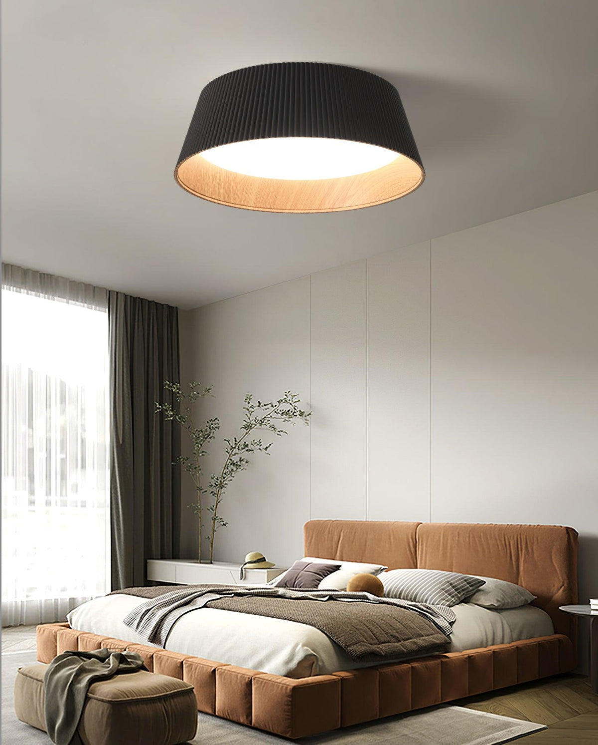 A black Clérachic ceiling light above a bedroom with a terracotta-coloured bed, a tall window and a grey wardrobe wall.