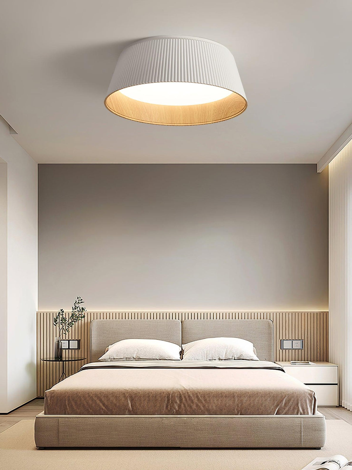White fluted Clérachic ceiling light above a bed with a slatted headboard wall and a warm beige bedcover.