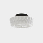 The white Clérachic fluted opal glass flush ceiling light turned to show its scalloped rim and rosette base.