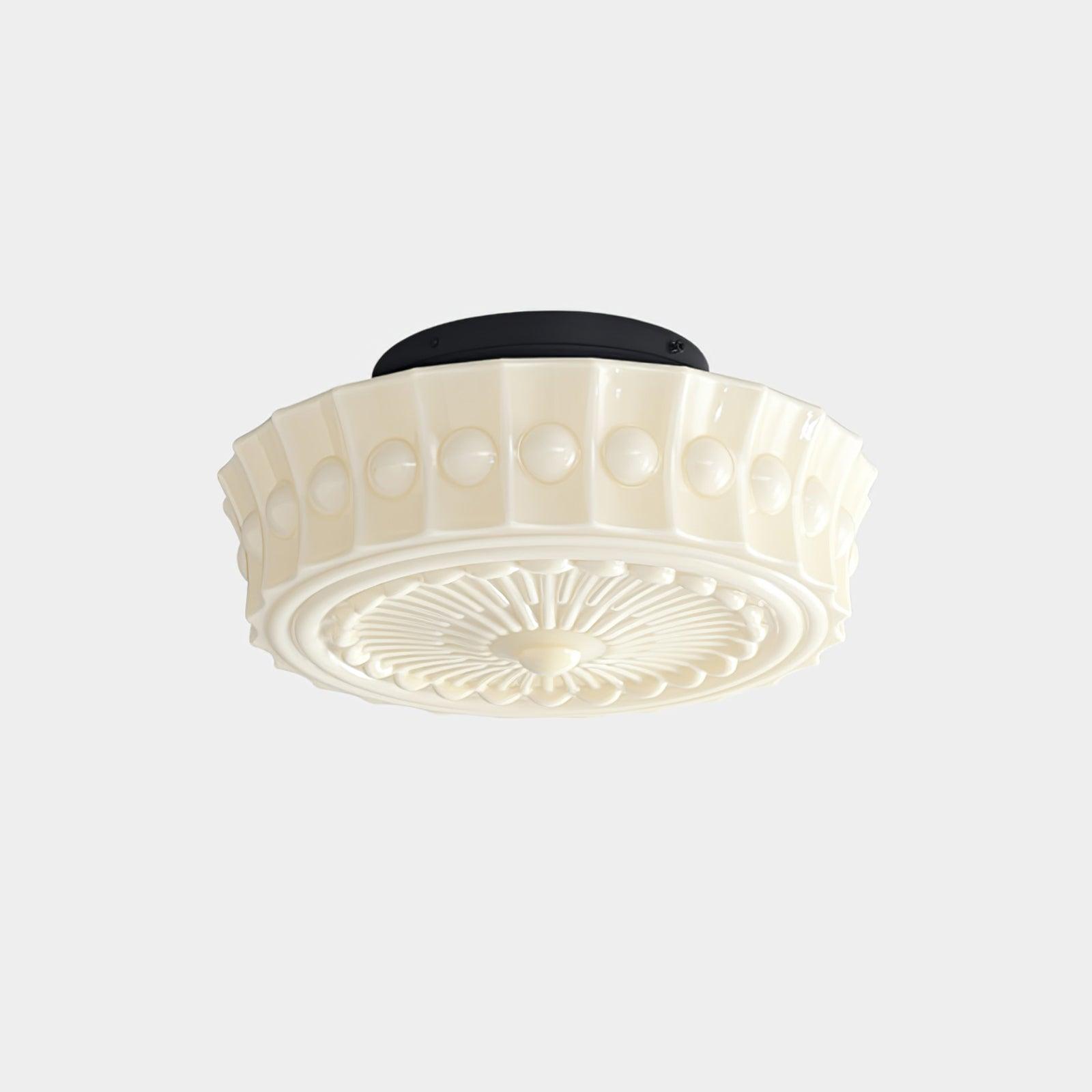 Head-on view of the beige Clérachic fluted opal glass flush ceiling light with its round black ceiling canopy.