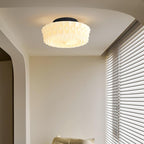 The beige Clérachic fluted opal glass flush ceiling light lit in an arched hallway leading to closet doors.