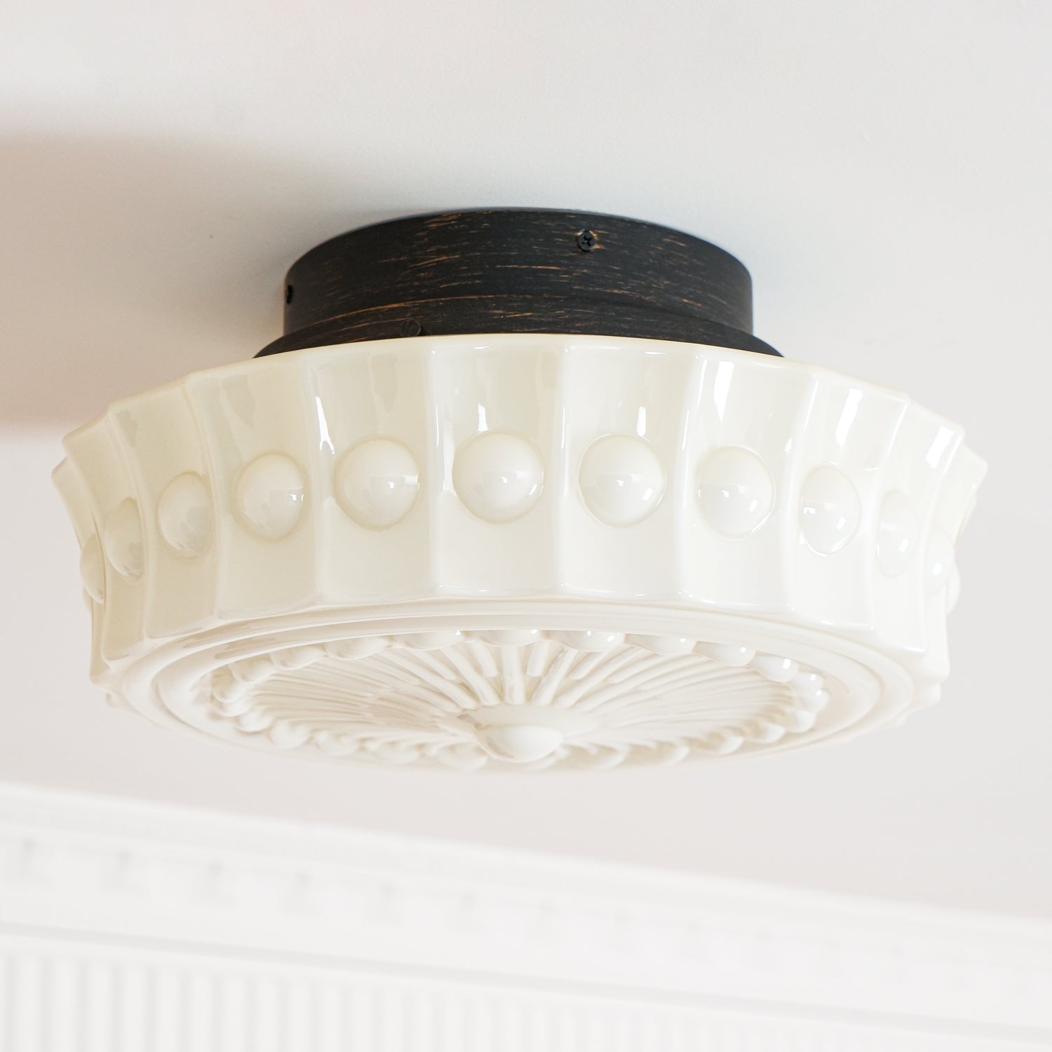 The white Clérachic fluted opal glass flush ceiling light photographed close, unlit, showing its fluted band.