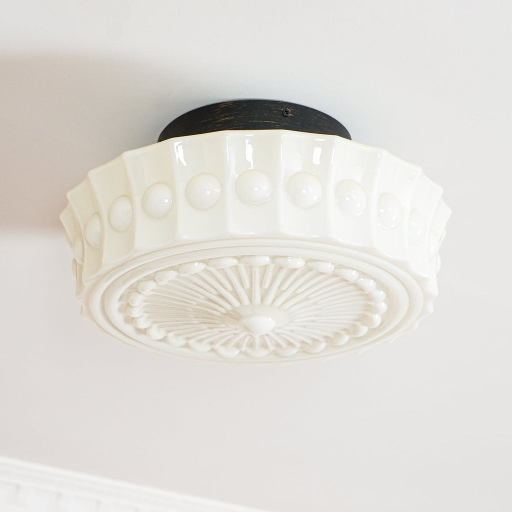 A second close studio angle of the unlit white Clérachic fluted opal glass flush ceiling light and its canopy.