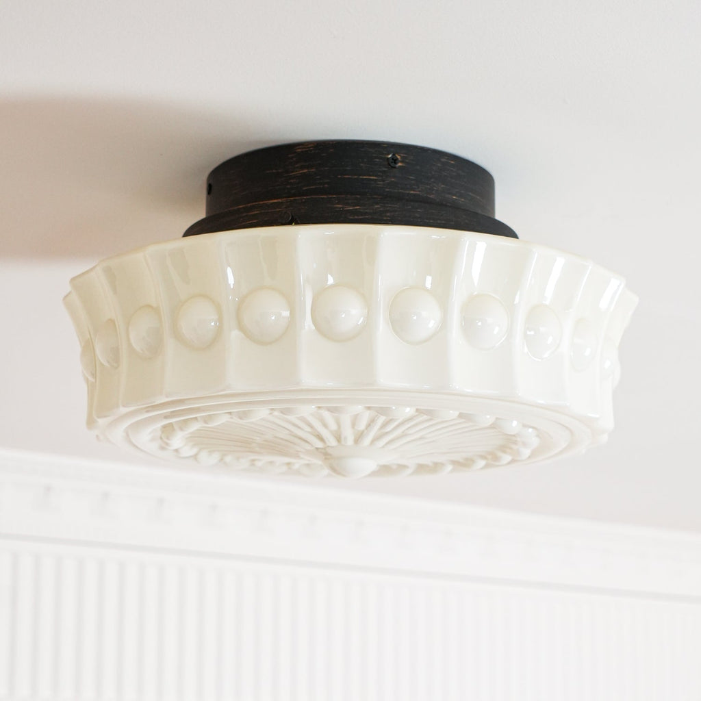 The white Clérachic fluted opal glass flush ceiling light shown unlit with its scalloped edge in sharp focus.