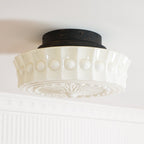 The white Clérachic fluted opal glass flush ceiling light shown unlit with its scalloped edge in sharp focus.
