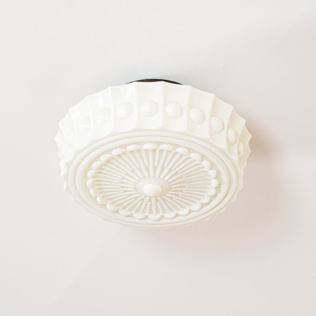 Cropped view of the white Clérachic fluted opal glass flush ceiling light with its canopy just out of frame.
