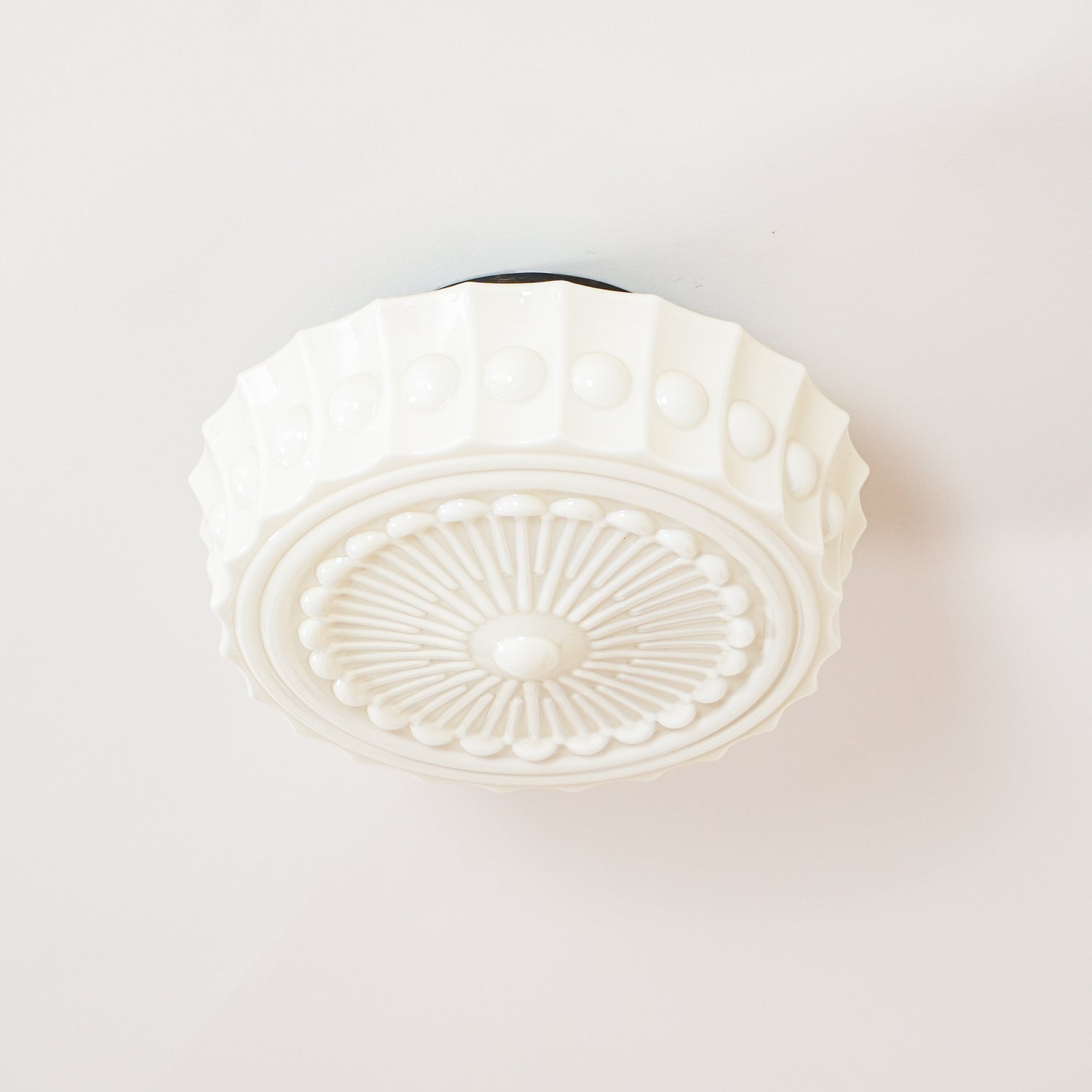 Cropped view of the white Clérachic fluted opal glass flush ceiling light with its canopy just out of frame.