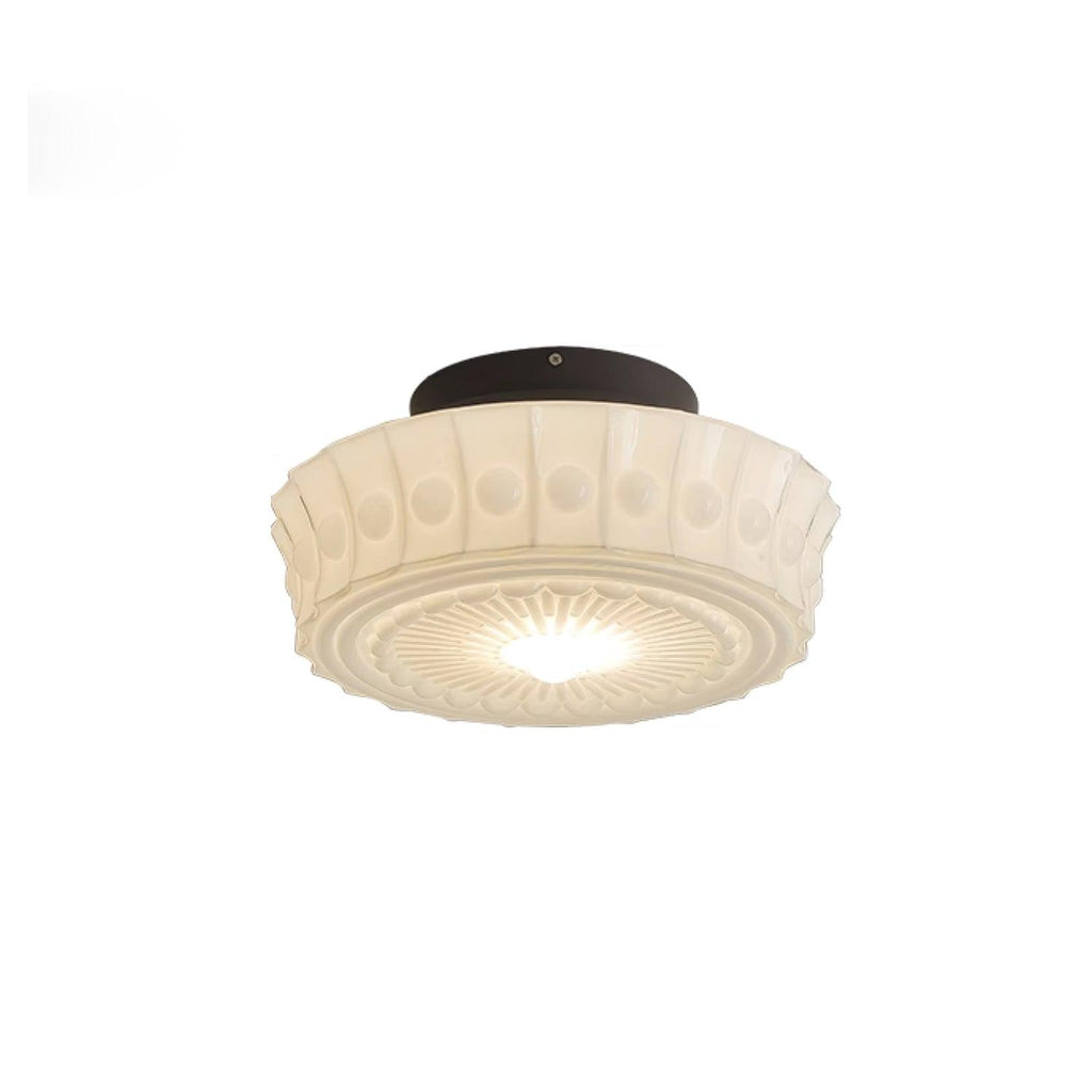 Straight-on studio shot of the white Clérachic fluted opal glass flush ceiling light switched on and glowing.