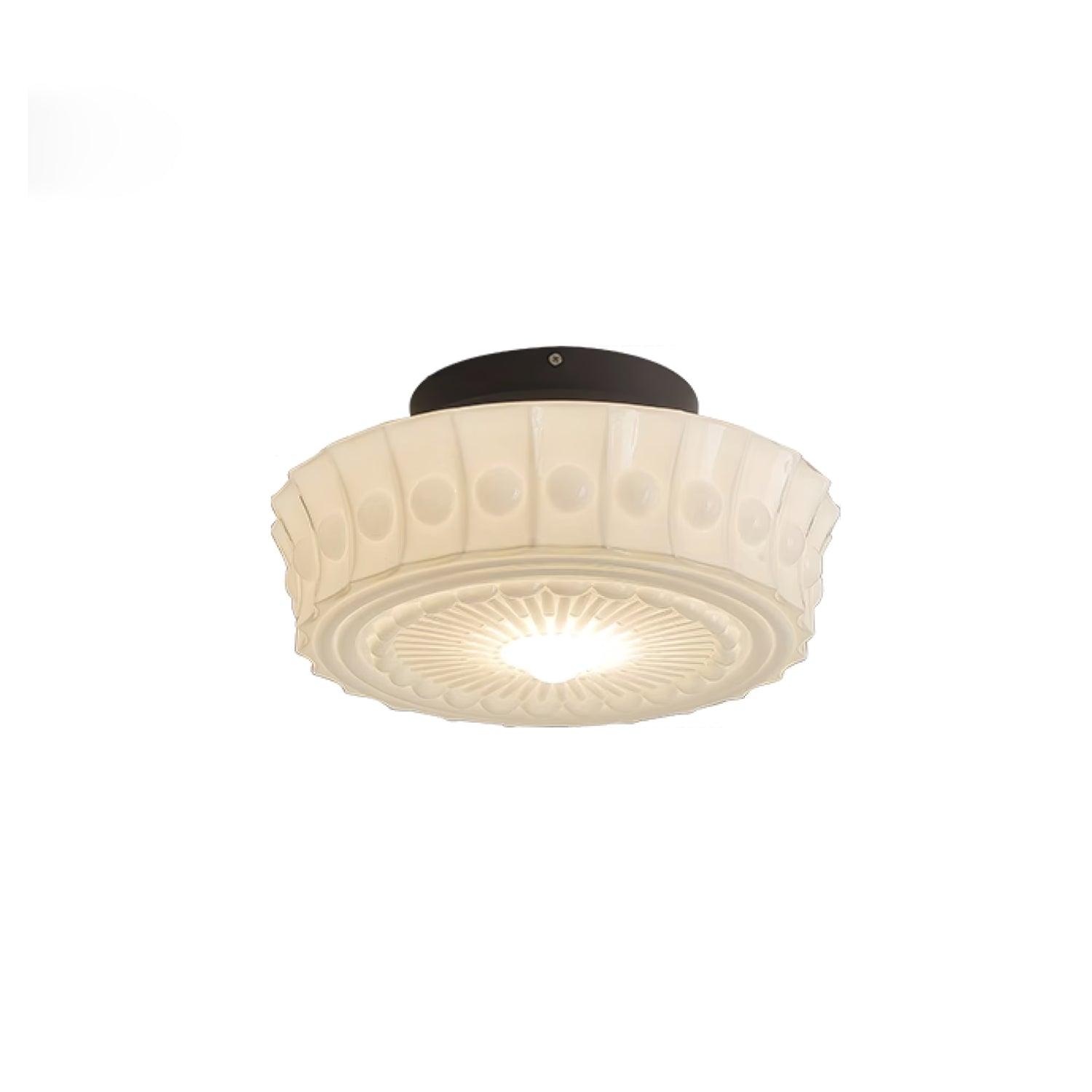 Straight-on studio shot of the white Clérachic fluted opal glass flush ceiling light switched on and glowing.