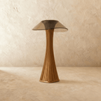 Clérachic bronze fluted table lamp with a smoked, wide-brimmed acrylic shade, switched off on a limewashed floor