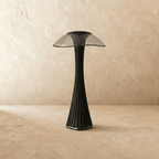 Clérachic black fluted table lamp with a smoked wide-brimmed shade, switched off on a limewashed floor