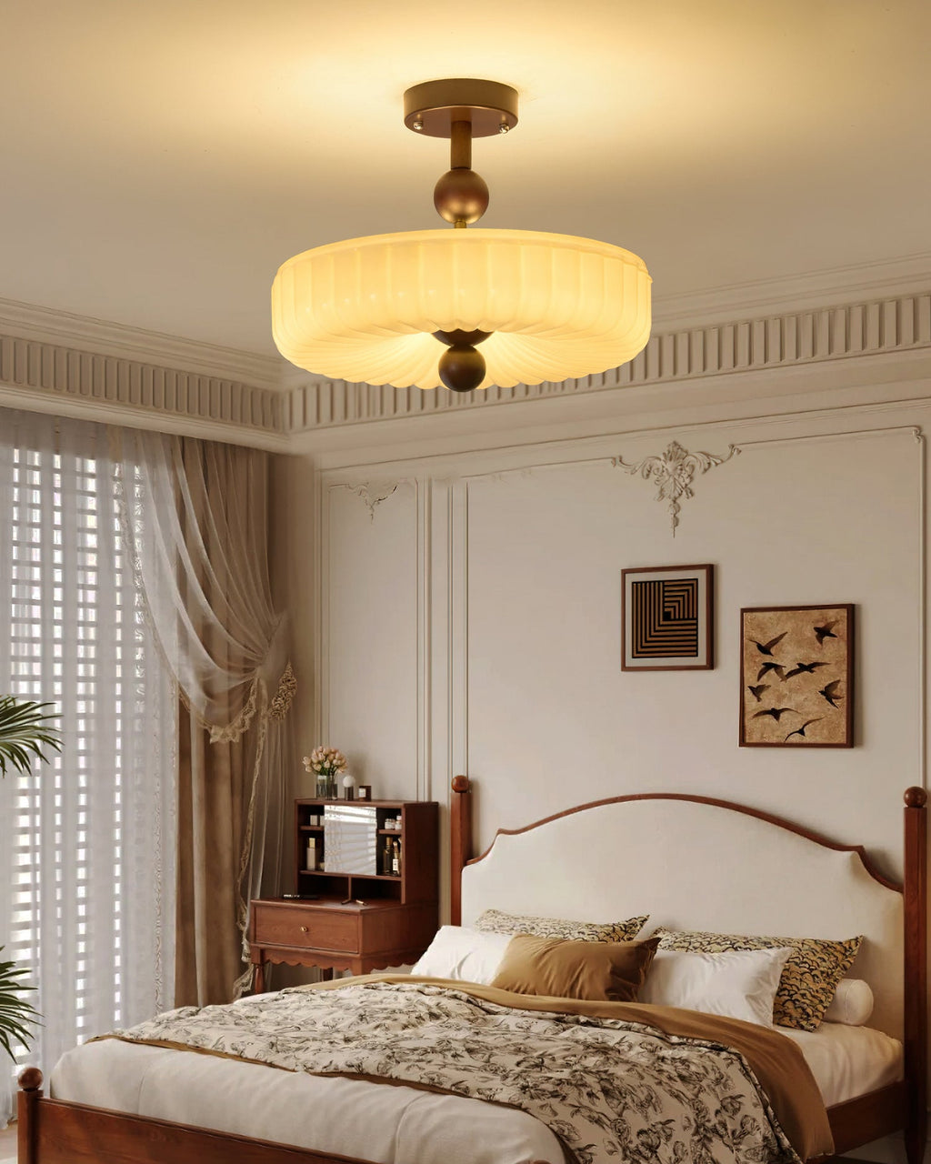 Lit fluted disc light from Clérachic below a corniced bedroom ceiling, with a wooden bed and floral bedding beneath.