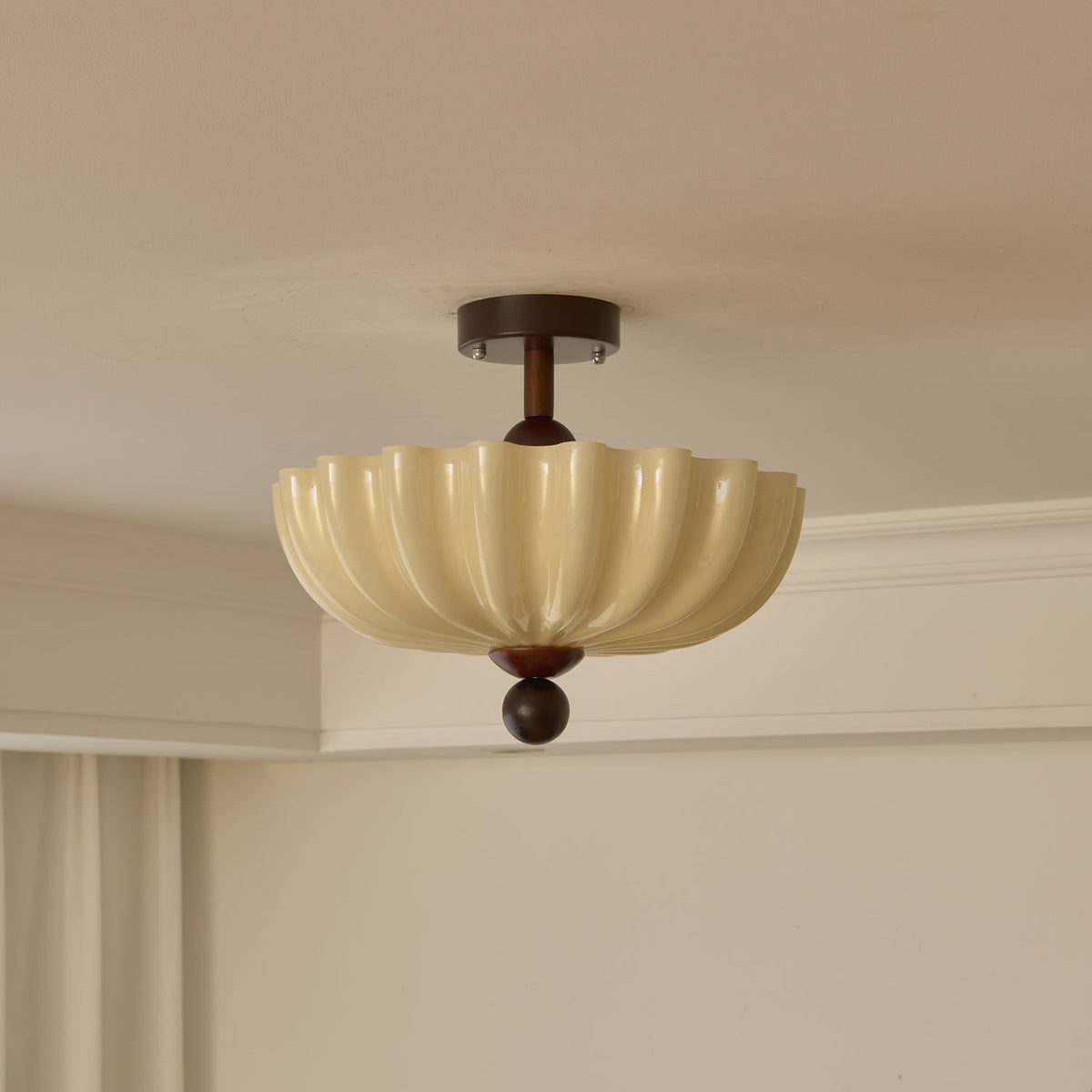 Unlit scalloped shade with walnut canopy and ball tip, this Clérachic ceiling light seen against a cream ceiling and cornice.