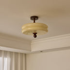 Unlit two-tier cream glass shade with a walnut stem and ball, this Clérachic ceiling light seen against a corner cornice.