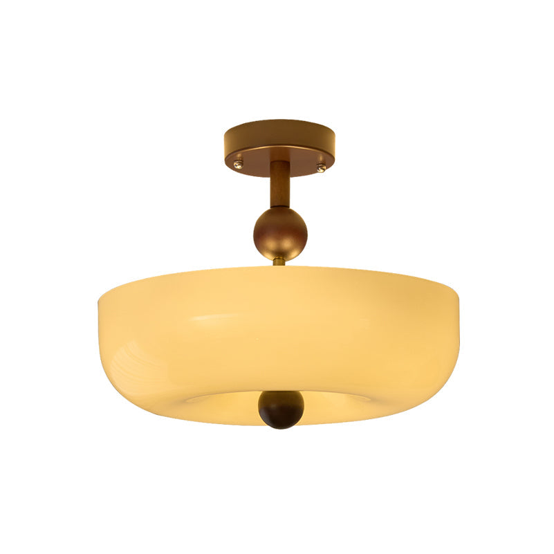 Wide shallow cream bowl shade, with walnut stem and ball, on this Clérachic ceiling light shown against a white backdrop.
