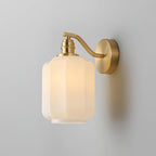 Clérachic Fluted White Glass Wall Sconce lit on a grey wall, its brushed brass swan-neck arm curving from a round backplate.