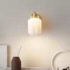 Clérachic Fluted White Glass Wall Sconce above a marble shelf, dropping a soft pool of light past a vase and a pale dish.