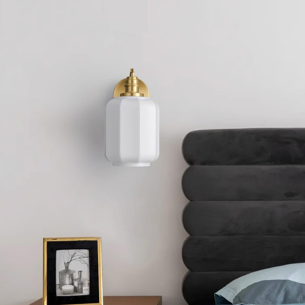 Unlit Clérachic Fluted White Glass Wall Sconce beside a charcoal channelled headboard, its gloss white shade catching daylight.