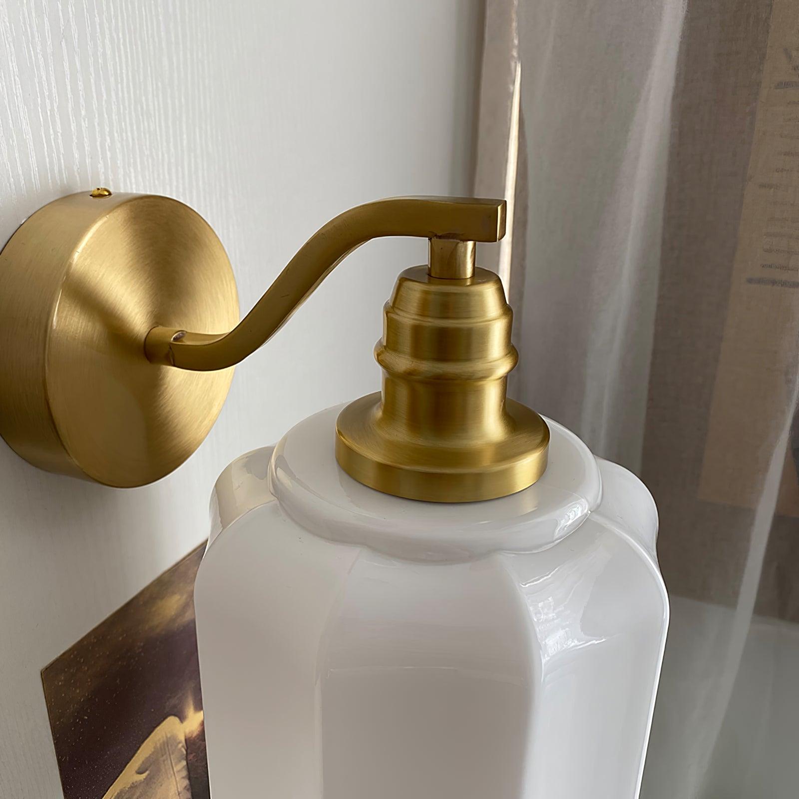 Detail of the Clérachic Fluted White Glass Wall Sconce: brushed brass backplate, swan-neck arm and stepped collar over the glass.