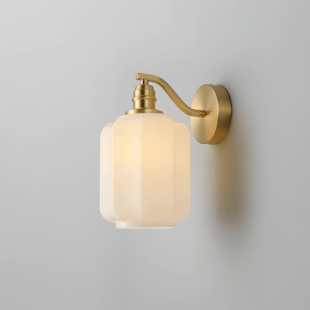 Angled studio view of the lit Clérachic Fluted White Glass Wall Sconce, brass hardware sharing one satin finish throughout.