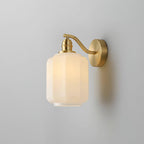 Angled studio view of the lit Clérachic Fluted White Glass Wall Sconce, brass hardware sharing one satin finish throughout.