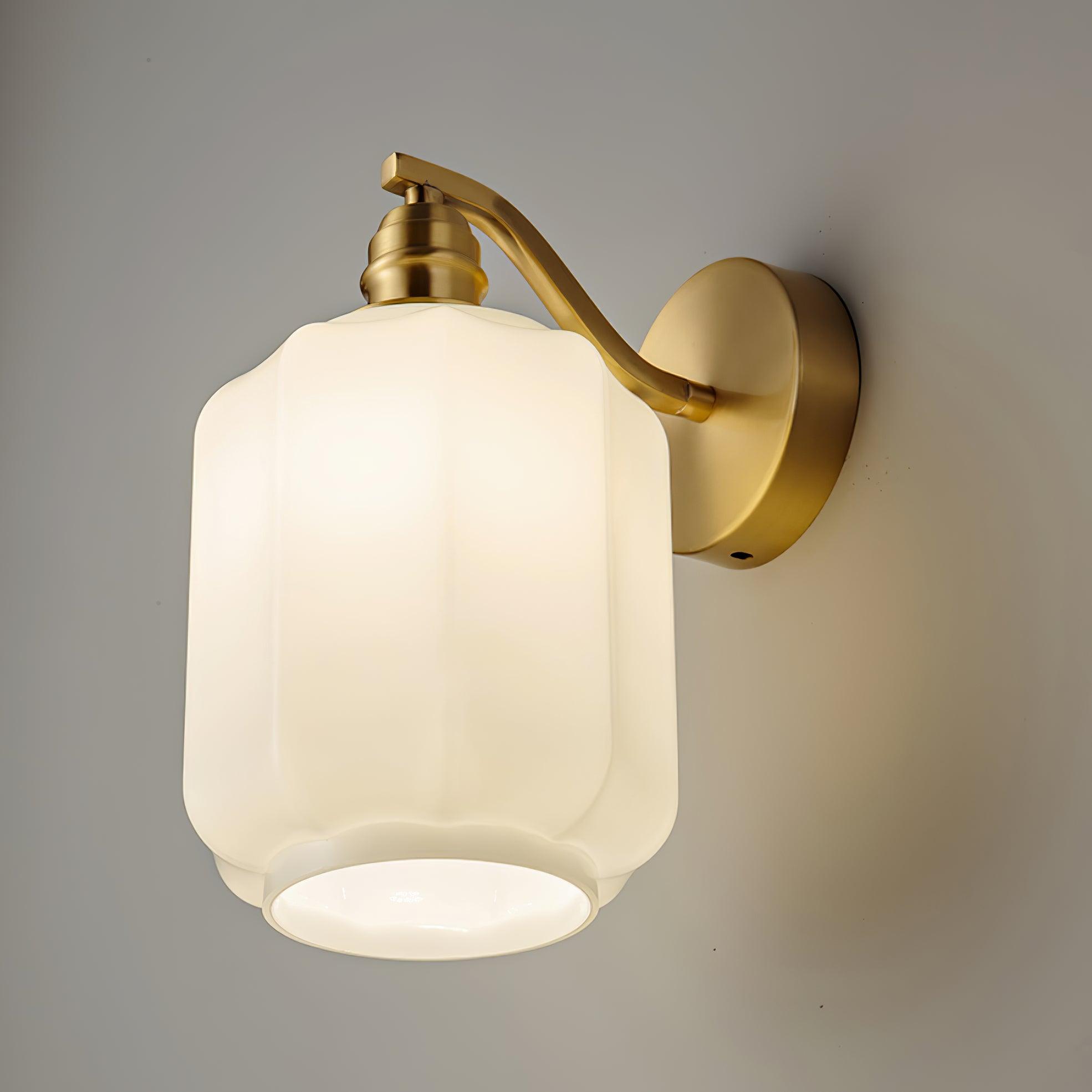 Clérachic Fluted White Glass Wall Sconce lit from a low angle, the open bottom rim showing the bright disc of light inside.